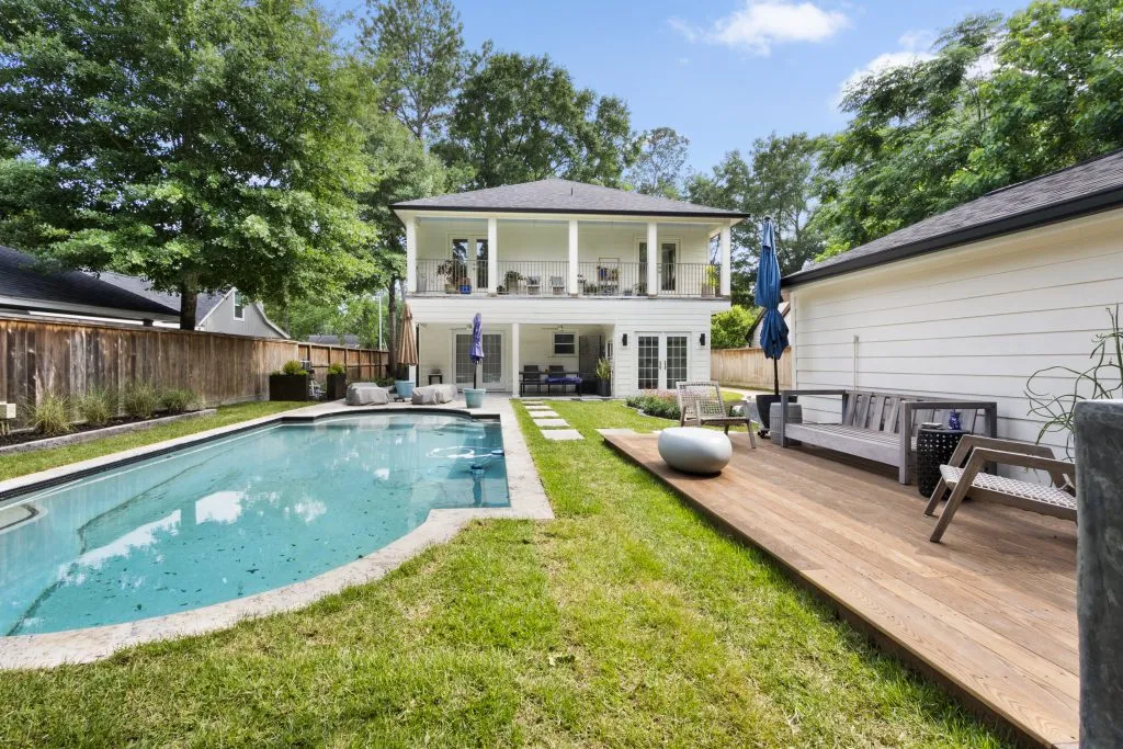 large arabesque pool with high-end decking and pavers